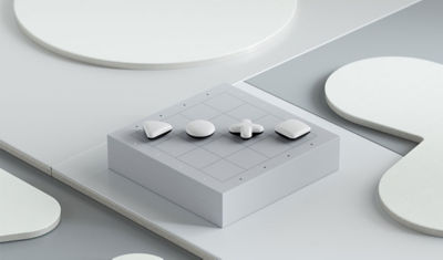 Black and white PlayStation Shapes pieces placed around the corner of a grey game board