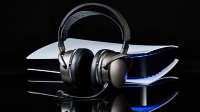 Audeze Maxwell 2 wireless headset with detachable microphone placed in front of a PlayStation 5 console.