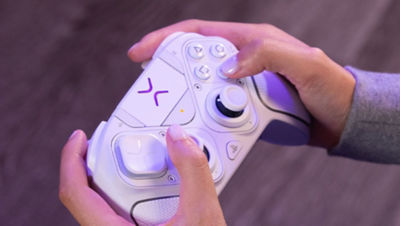 Close up of someone holding a white Victrix controller 