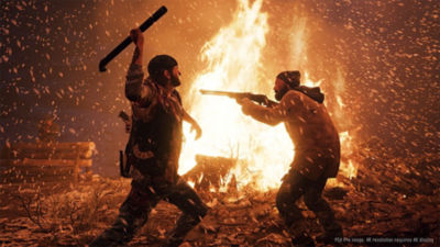 Days Gone star Deacon St. John stands in front of a bonfire and prepares to strike a man who is pointing a shotgun at him with a metal pipe.